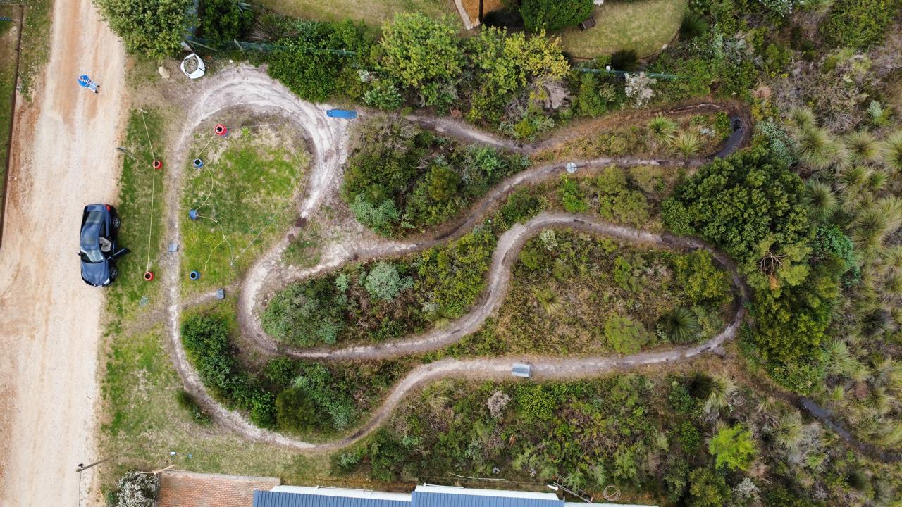 Aerial view of the Barbara Road site during groundworks, showing cleared access paths through coastal fynbos