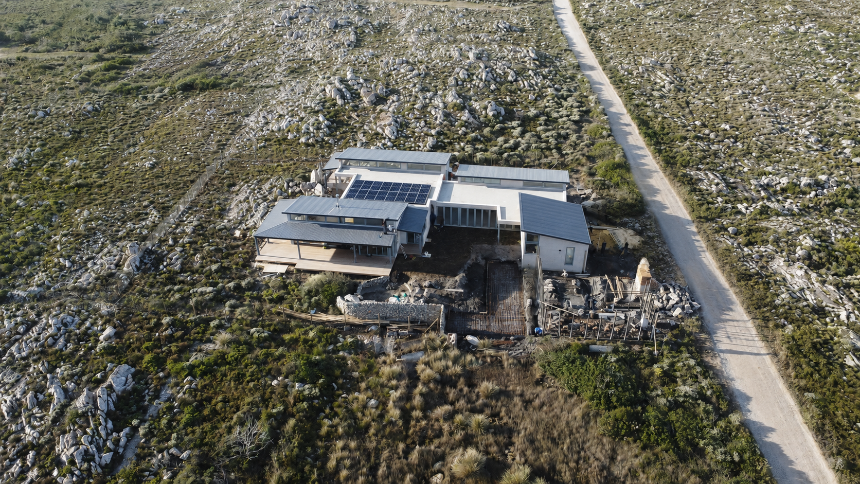 Aerial view of the Sunny Seas House, a low contemporary home set into coastal fynbos at Betty's Bay